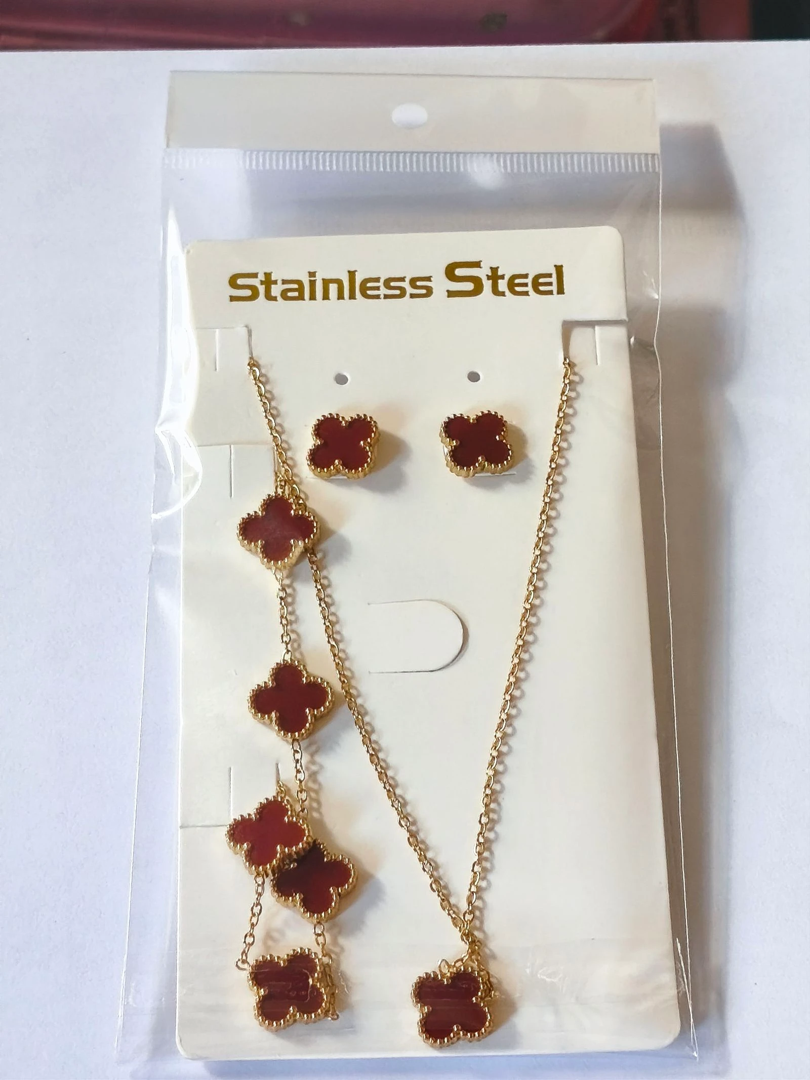 Conjunto de gargantilla pulsera y pendientes de trebol color rojo con cadena dorada de acero